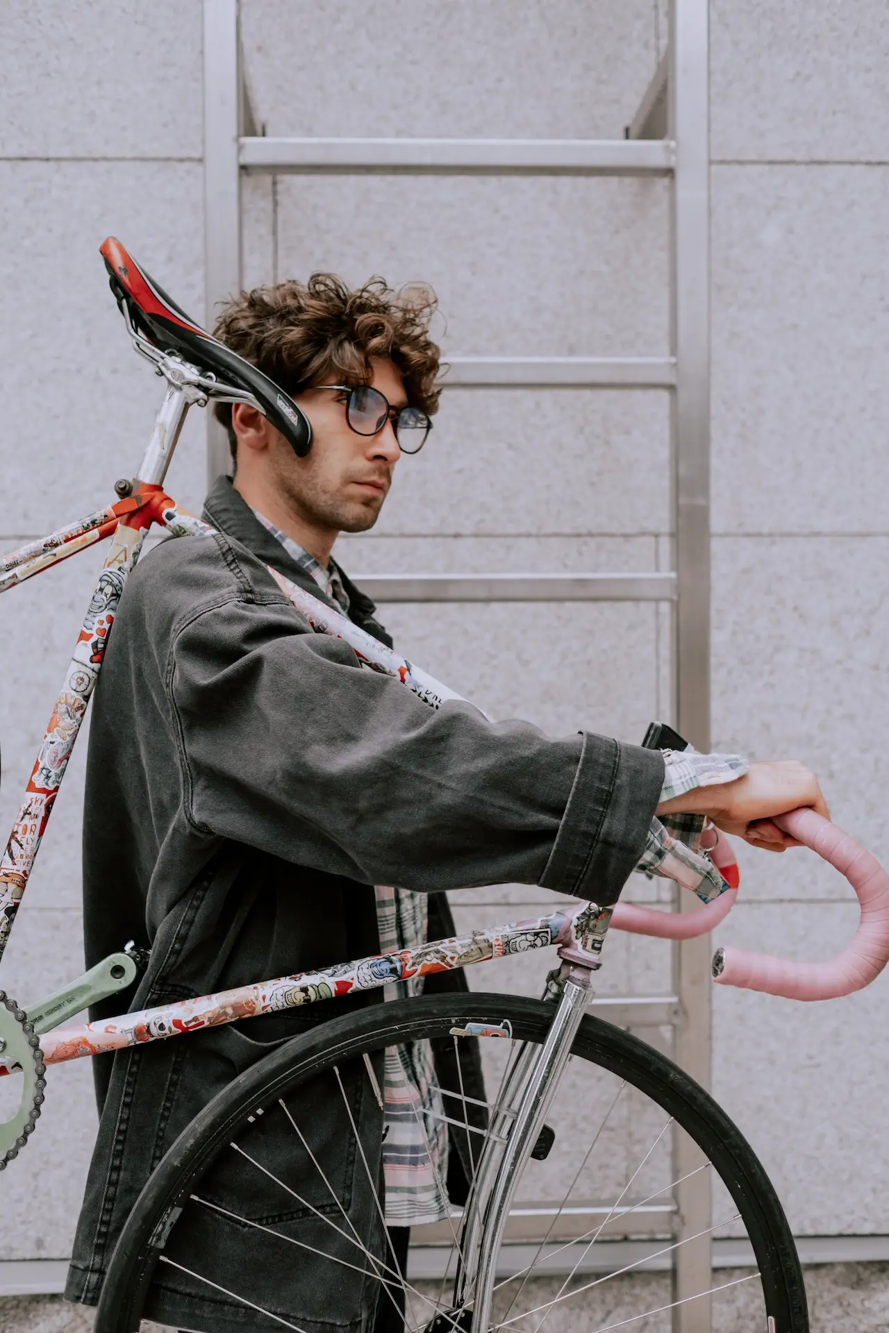 Man walking while holding a bike